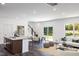 Open-concept living room with a modern design, filled with natural light and a view of the backyard at 174 Blue Butterfly Dr, Angier, NC 27501