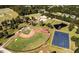 Aerial view of ball fields, a pond, and surrounding trees at 182 Blue Butterfly Dr, Angier, NC 27501
