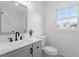 Bathroom with updated vanity, modern fixtures, and decorative mirror at 200 Arlington Cir Cir, Sanford, NC 27330
