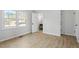 Bright, airy bedroom with ample natural light, showcasing modern flooring and neutral decor at 200 Arlington Cir Cir, Sanford, NC 27330