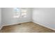 Bedroom with hardwood floors and large windows bringing in natural light at 200 Arlington Cir Cir, Sanford, NC 27330