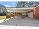 Spacious carport with a covered deck and access to the house at 200 Arlington Cir Cir, Sanford, NC 27330