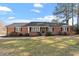 Beautiful brick home with a well-maintained lawn, inviting front porch, and mature trees at 200 Arlington Cir Cir, Sanford, NC 27330