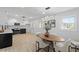 Well-lit kitchen with stainless steel appliances, adjacent to a charming eat-in area with stylish decor at 200 Arlington Cir Cir, Sanford, NC 27330