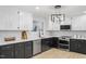 Stylish kitchen featuring black lower cabinets, white upper cabinets, and stainless steel appliances at 200 Arlington Cir Cir, Sanford, NC 27330