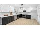 Modern kitchen with black and white cabinetry, stainless steel appliances and updated lighting at 200 Arlington Cir Cir, Sanford, NC 27330