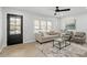 Cozy living room with a modern ceiling fan, plush seating and abundant natural light at 200 Arlington Cir Cir, Sanford, NC 27330