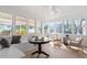 Bright sunroom with floor-to-ceiling windows, comfortable seating and a chess set at 200 Arlington Cir Cir, Sanford, NC 27330