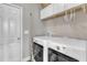 Bright laundry room featuring washer, dryer, shelving, and white cabinets at 2005 Cotton Barn Ct, Wendell, NC 27591