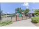 Community playground with slides, climbing structures, and a lake in the background at 2005 Cotton Barn Ct, Wendell, NC 27591