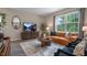 Cozy living room featuring modern furniture, a large window, wood floors, and a stylish area rug at 2006 Fletcher'S Ridge Dr, Durham, NC 27703