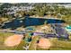 Aerial view of the community lake, tennis courts, playground, and ball fields at 204 Blue Butterfly Dr, Angier, NC 27501