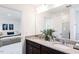 Elegant bathroom with double vanity, granite countertops, and a view into the Primary bedroom at 204 Blue Butterfly Dr, Angier, NC 27501