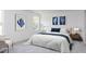 Cozy bedroom featuring a comfortable bed, soft lighting, and a serene atmosphere with stylish artwork at 204 Blue Butterfly Dr, Angier, NC 27501