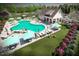 Aerial view of the community pool featuring ample seating, cabanas, and lush landscaping at 204 Blue Butterfly Dr, Angier, NC 27501