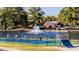 Community tennis court with a lake view, fountain and lush greenery at 204 Blue Butterfly Dr, Angier, NC 27501