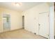 Cozy bedroom featuring neutral walls, carpet, and a view into the bathroom at 204 N Sixth St, Mebane, NC 27302