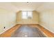 Bedroom featuring vintage wallpaper, hardwood floors, and a window at 204 N Sixth St, Mebane, NC 27302