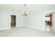 Bright dining room with vintage chandelier and open access to other rooms at 204 N Sixth St, Mebane, NC 27302