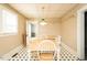 Bright dining area with classic black and white flooring, table, and chairs at 204 N Sixth St, Mebane, NC 27302