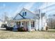 An inviting two-story home showcasing its exterior details, including a cozy front porch and well-kept lawn at 204 N Sixth St, Mebane, NC 27302