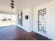 Welcoming front porch features a black door with glass panes, a tiled floor and a classic hanging lantern at 204 N Sixth St, Mebane, NC 27302