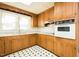 Traditional kitchen with wood cabinets, white countertops, and a window over the sink at 204 N Sixth St, Mebane, NC 27302