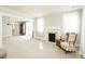 Cozy living room with fireplace and large windows, creating a warm and inviting atmosphere at 204 N Sixth St, Mebane, NC 27302