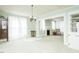Spacious living room bathed in natural light, featuring a decorative fireplace and classic chandelier at 204 N Sixth St, Mebane, NC 27302