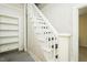 White stairway with painted risers and a built-in bookshelf offers charm at 204 N Sixth St, Mebane, NC 27302