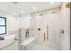 Modern bathroom featuring a glass-enclosed shower with gold fixtures and marble-style tiling at 207 Linden Ave, Raleigh, NC 27601