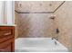 Close-up of a tiled tub with a shower, complemented by a wooden vanity at 207 Linden Ave, Raleigh, NC 27601