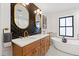 Elegant bathroom with a double vanity, herringbone backsplash, and a freestanding soaking tub, perfect for relaxation at 207 Linden Ave, Raleigh, NC 27601