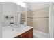 Bathroom featuring a shower-tub combination and a single sink vanity with wooden cabinets at 207 Linden Ave, Raleigh, NC 27601