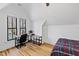 Cozy bedroom featuring hardwood floors, a workspace area, and plenty of natural light at 207 Linden Ave, Raleigh, NC 27601