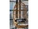 Close-up of a hanging wicker chair with pillow at 207 Linden Ave, Raleigh, NC 27601