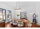 Elegant dining room with a long wooden table, modern chairs, and a stylish chandelier at 207 Linden Ave, Raleigh, NC 27601