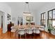 Bright dining room with hardwood floors, a large dining table, and modern decor at 207 Linden Ave, Raleigh, NC 27601