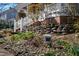 Charming home featuring a landscaped front yard with emerging plants and a quaint stone wall at 207 Linden Ave, Raleigh, NC 27601