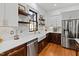 This kitchen boasts modern appliances, white subway tile backsplash, and floating shelves at 207 Linden Ave, Raleigh, NC 27601