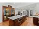 Kitchen island with marble countertop, wine fridge, microwave, and dark wood cabinets at 207 Linden Ave, Raleigh, NC 27601