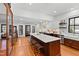 Bright, modern kitchen features an island with seating, stainless steel appliances, and wood floors at 207 Linden Ave, Raleigh, NC 27601