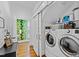 Functional laundry area with a washer, dryer, and easy access to an adjacent powder room at 207 Linden Ave, Raleigh, NC 27601