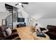 Large entertainment room featuring a unique spiral staircase with a ceiling fan, TV, and rocking chair at 207 Linden Ave, Raleigh, NC 27601