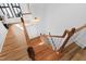 Staircase featuring wooden steps and white railings, with natural light streaming in at 207 Linden Ave, Raleigh, NC 27601