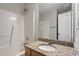 Bathroom with granite counter, shower, and white fixtures at 2121 Ramsgate St, Raleigh, NC 27603