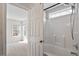 Bathroom featuring a tiled shower and a white paneled door, adjacent to a neutrally decorated bedroom at 2121 Ramsgate St, Raleigh, NC 27603