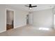 Spacious bedroom with neutral carpet, fan and two entrance doorways at 2121 Ramsgate St, Raleigh, NC 27603
