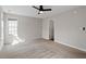 Spacious bedroom with neutral carpet, fan and a large window at 2121 Ramsgate St, Raleigh, NC 27603