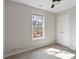 Bright bedroom featuring a large window and neutral walls and carpet at 2121 Ramsgate St, Raleigh, NC 27603